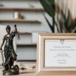 selectvie focus photo of a lady justice statuette and diploma