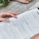 person holding home insurance form
